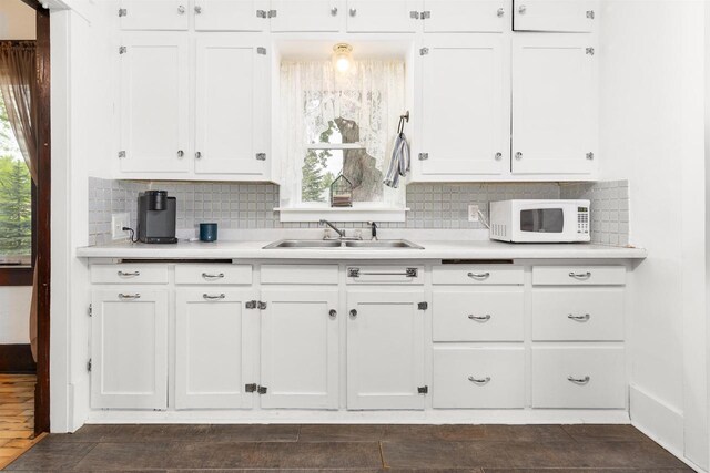 25 E 1st St, Clintonville, WI 54929 - kitchen featuring white microwave, a sink, white cabinetry, and light countertops