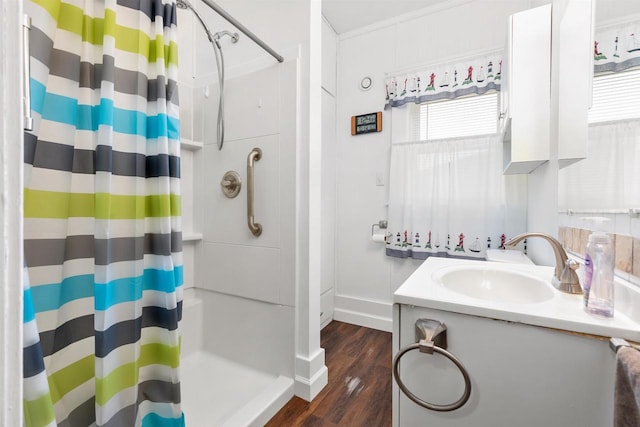 25 E 1st St, Clintonville, WI 54929 - full bath featuring wood finished floors, a shower with curtain, vanity, and baseboards