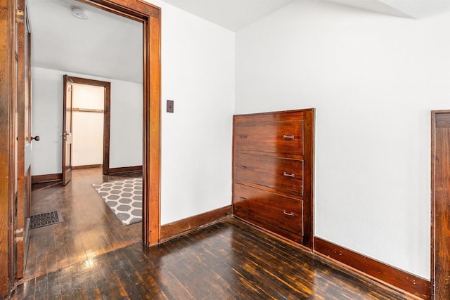 25 E 1st St, Clintonville, WI 54929 - unfurnished room with wood finished floors, baseboards, a smoke detector, and lofted ceiling