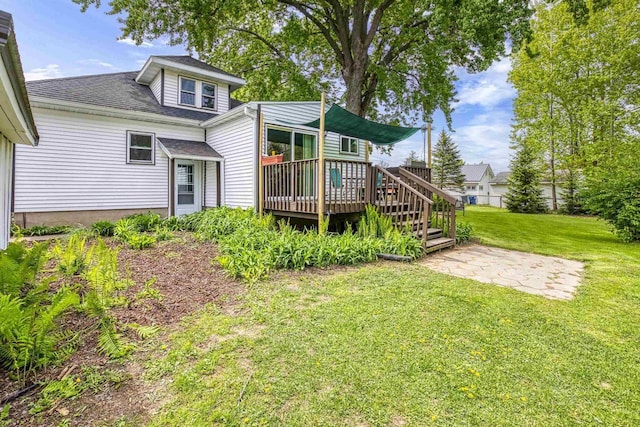 25 E 1st St, Clintonville, WI 54929 - rear view of property with a wooden deck, a lawn, a patio area, and roof with shingles
