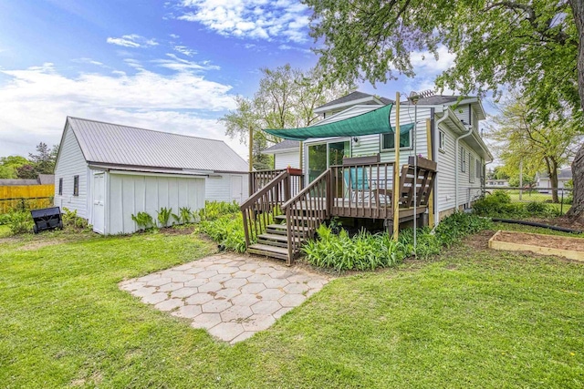 25 E 1st St, Clintonville, WI 54929 - rear view of property featuring a wooden deck, a patio area, and an outbuilding