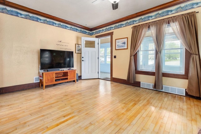 25 E 1st St, Clintonville, WI 54929 - unfurnished living room with hardwood / wood-style flooring, a ceiling fan, crown molding, and baseboards