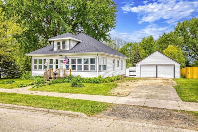 25 E 1st St, Clintonville, WI 54929 - bungalow-style home with a detached garage, an outbuilding, and a shingled roof