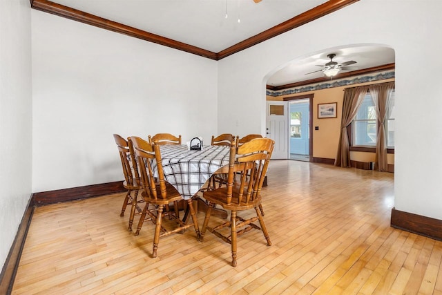 25 E 1st St, Clintonville, WI 54929 - dining space featuring arched walkways, ceiling fan, wood-type flooring, crown molding, and baseboards