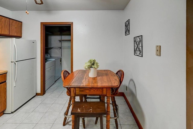 887 Kottke Dr Unit 887, Madison, WI 53719 - dining space featuring washing machine and clothes dryer, light tile patterned floors, and baseboards