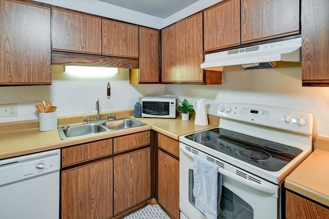 887 Kottke Dr Unit 887, Madison, WI 53719 - kitchen with white appliances, under cabinet range hood, a sink, light countertops, and brown cabinets