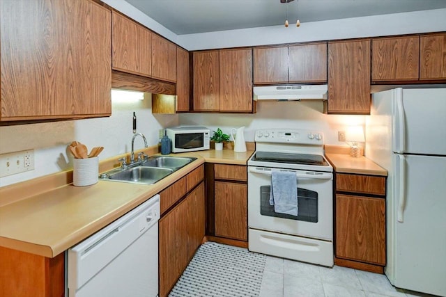 887 Kottke Dr Unit 887, Madison, WI 53719 - kitchen featuring white appliances, under cabinet range hood, a sink, light countertops, and brown cabinetry