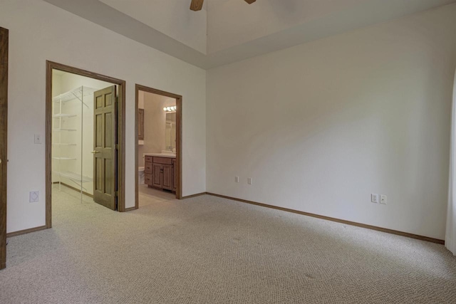 3205 N Mistwood Ln, Appleton, WI 54914 - unfurnished bedroom with light colored carpet, baseboards, ensuite bath, and a ceiling fan