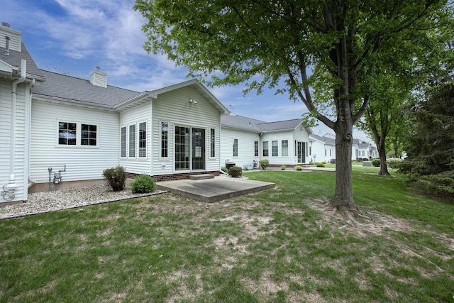 3205 N Mistwood Ln, Appleton, WI 54914 - rear view of property featuring a patio area, a yard, a chimney, and a shingled roof