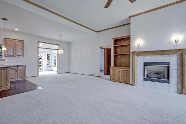 3205 N Mistwood Ln, Appleton, WI 54914 - unfurnished living room with carpet floors, a ceiling fan, crown molding, a tile fireplace, and recessed lighting