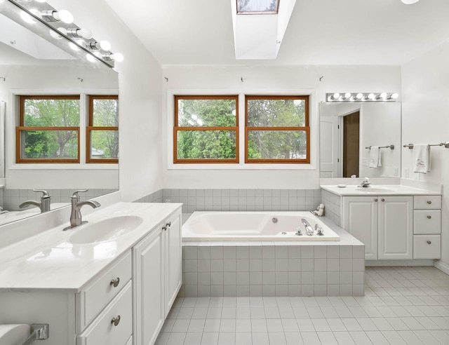 483 W S St Unit A, Lake Geneva, WI 53147 - full bathroom with tile patterned floors, a skylight, two vanities, a bath, and healthy amount of natural light