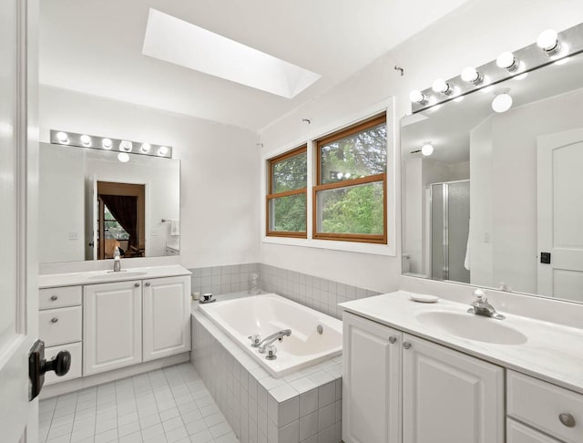 483 W S St Unit A, Lake Geneva, WI 53147 - full bathroom featuring a skylight, a stall shower, a bath, tile patterned flooring, and two vanities