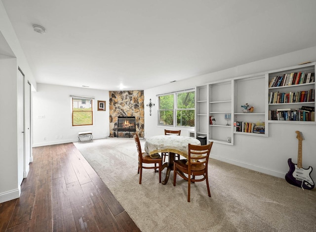 483 W S St Unit A, Lake Geneva, WI 53147 - dining space with a stone fireplace, healthy amount of natural light, baseboards, and wood-type flooring