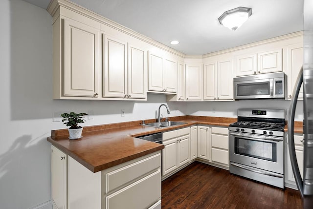 483 W S St Unit A, Lake Geneva, WI 53147 - kitchen with stainless steel appliances, a sink, dark countertops, dark wood-type flooring, and recessed lighting