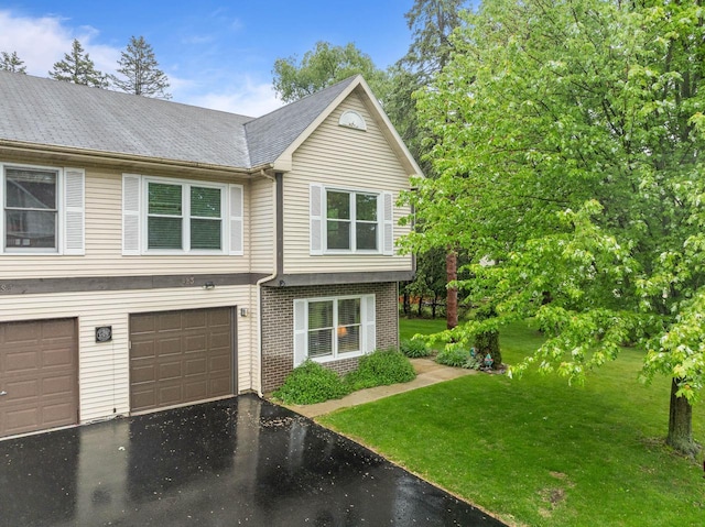 483 W S St Unit A, Lake Geneva, WI 53147 - view of front of home featuring driveway, brick siding, a front yard, and an attached garage