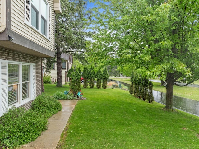 483 W S St Unit A, Lake Geneva, WI 53147 - view of green lawn featuring a water view