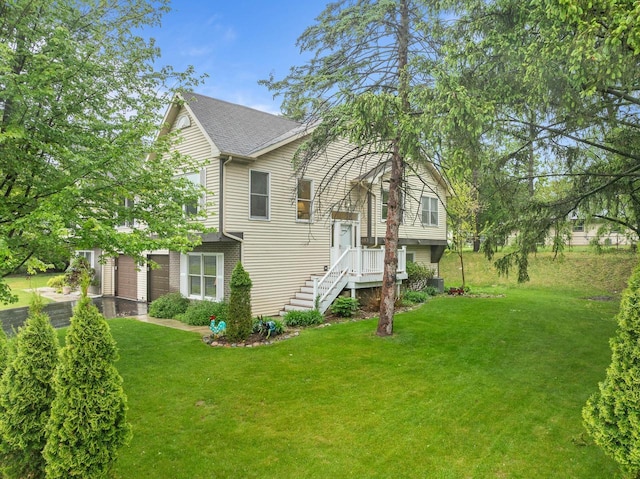 483 W S St Unit A, Lake Geneva, WI 53147 - view of front of home featuring a front lawn, a garage, a shingled roof, and asphalt driveway