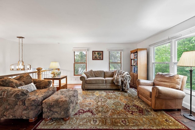 483 W S St Unit A, Lake Geneva, WI 53147 - living room with wood finished floors, healthy amount of natural light, a chandelier, and baseboards
