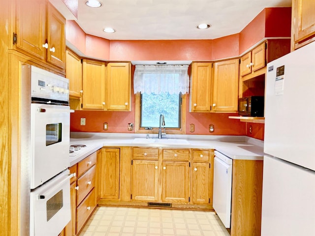 1965 Rockfence Ln, Beloit, WI 53511 - kitchen with white appliances, a sink, light floors, light countertops, and recessed lighting
