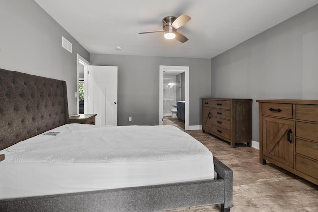 9435 402nd Ave, Genoa City, WI 53128 - bedroom with light wood-style flooring, ensuite bath, and a ceiling fan