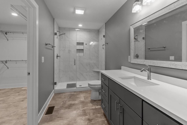 9435 402nd Ave, Genoa City, WI 53128 - bathroom with a shower stall, a walk in closet, vanity, wood finished floors, and recessed lighting