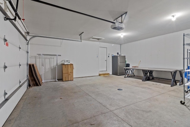 9435 402nd Ave, Genoa City, WI 53128 - garage featuring freestanding refrigerator and a garage door opener