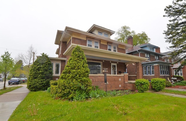 3524 Washington Ave, Racine, WI 53402 - american foursquare style home featuring brick siding, a front yard, and covered porch