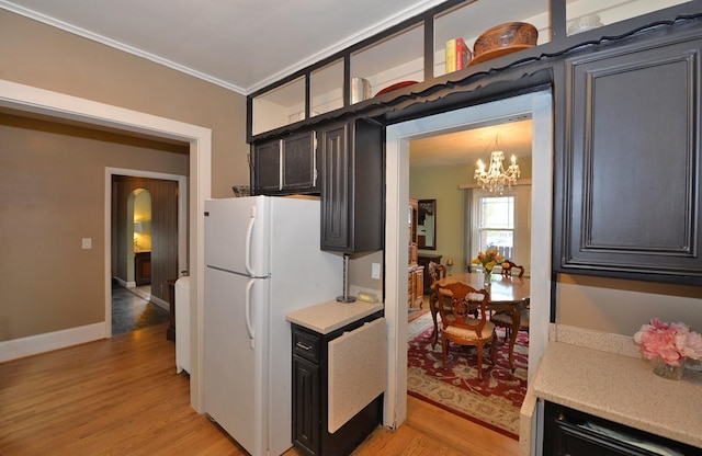 3524 Washington Ave, Racine, WI 53402 - kitchen with freestanding refrigerator, light wood-style floors, a chandelier, light countertops, and crown molding