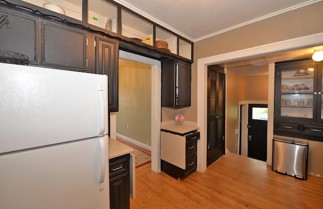 3524 Washington Ave, Racine, WI 53402 - kitchen featuring freestanding refrigerator, light countertops, ornamental molding, light wood finished floors, and glass insert cabinets