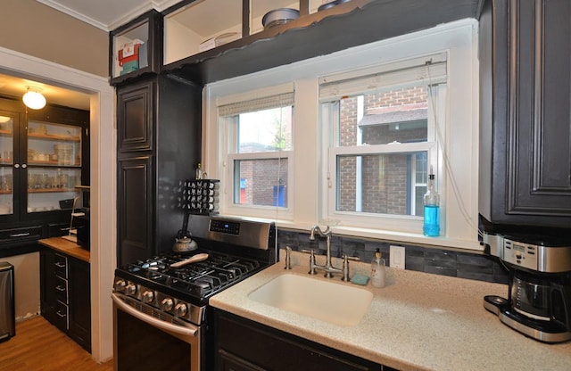 3524 Washington Ave, Racine, WI 53402 - kitchen featuring stainless steel gas stove, a sink, light countertops, and light wood-style flooring