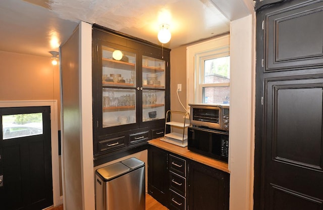 3524 Washington Ave, Racine, WI 53402 - kitchen with black microwave and glass insert cabinets