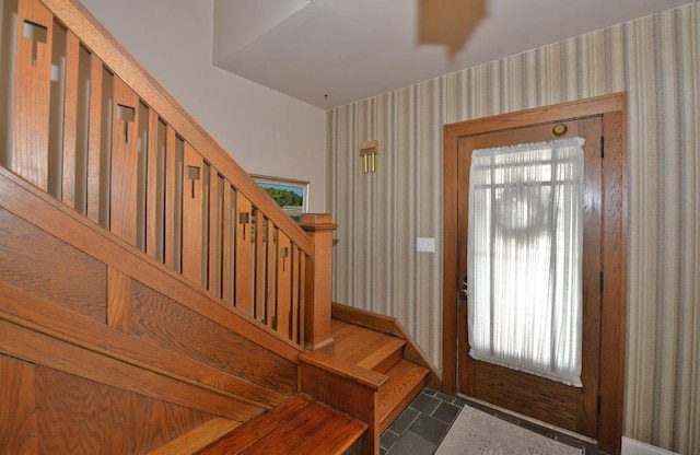 3524 Washington Ave, Racine, WI 53402 - entryway with wallpapered walls, stairs, baseboards, and stone finish flooring