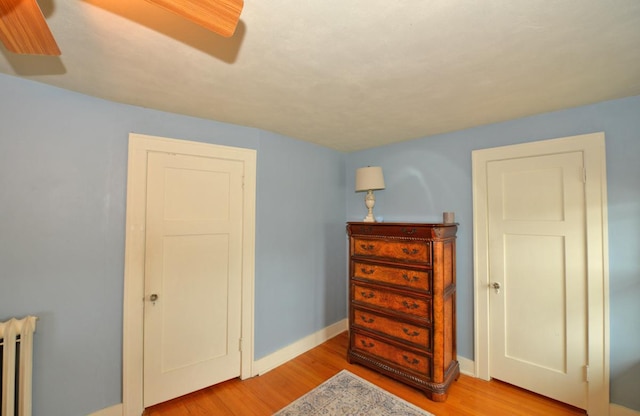 3524 Washington Ave, Racine, WI 53402 - bedroom featuring radiator, light wood-style flooring, and baseboards