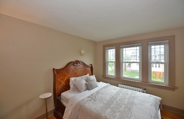 3524 Washington Ave, Racine, WI 53402 - bedroom with radiator heating unit, baseboards, and wood finished floors