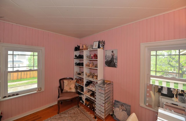 3524 Washington Ave, Racine, WI 53402 - sitting room with wood finished floors, crown molding, wood walls, and baseboards