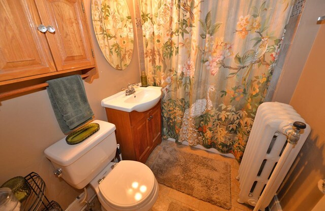 3524 Washington Ave, Racine, WI 53402 - bathroom featuring radiator heating unit, vanity, toilet, and a shower with shower curtain