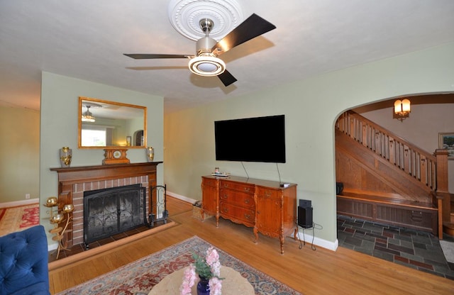 3524 Washington Ave, Racine, WI 53402 - living area with a ceiling fan, a fireplace, stairway, arched walkways, and wood finished floors