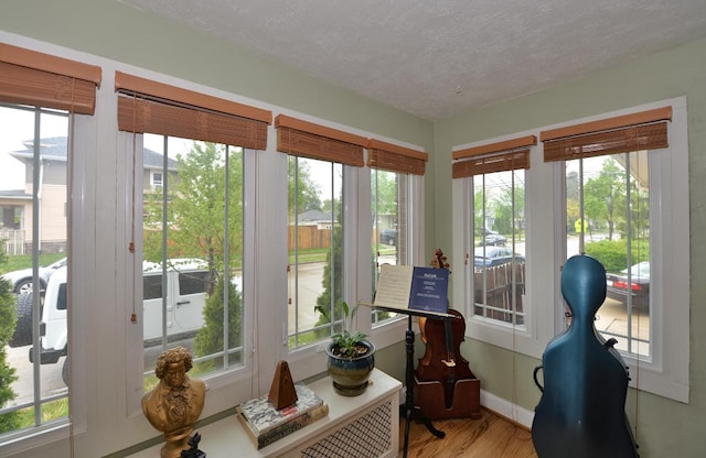 3524 Washington Ave, Racine, WI 53402 - sunroom / solarium with wood finished floors, a textured ceiling, and baseboards