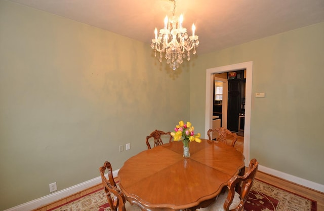 3524 Washington Ave, Racine, WI 53402 - dining space with a chandelier, baseboards, and wood finished floors
