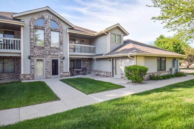 2116 Woodburn Rd Unit B, Waukesha, WI 53188 - view of property with a balcony, a front yard, and roof with shingles