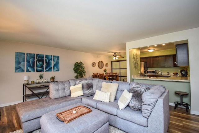 2116 Woodburn Rd Unit B, Waukesha, WI 53188 - living area with dark wood-style flooring, a ceiling fan, and baseboards
