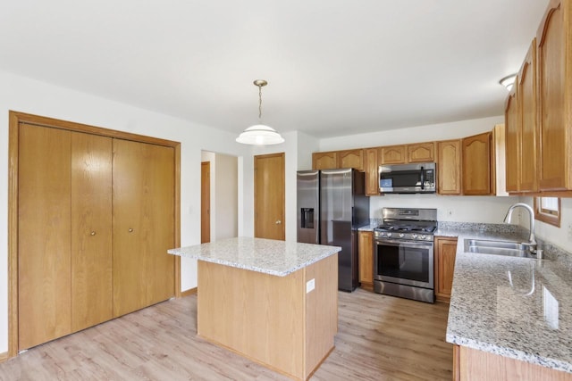 24434 88th St, Salem, WI 53168 - kitchen with appliances with stainless steel finishes, a sink, light wood finished floors, and light stone countertops