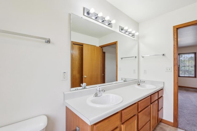 24434 88th St, Salem, WI 53168 - bathroom featuring double vanity, toilet, and baseboards