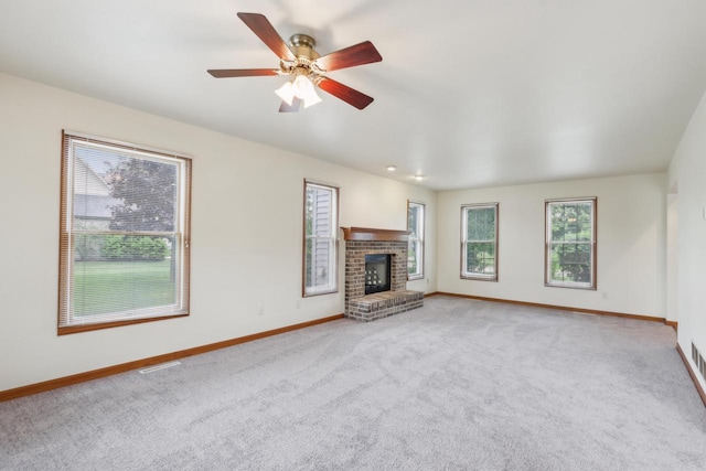 24434 88th St, Salem, WI 53168 - unfurnished living room featuring baseboards, carpet, a fireplace, and a ceiling fan