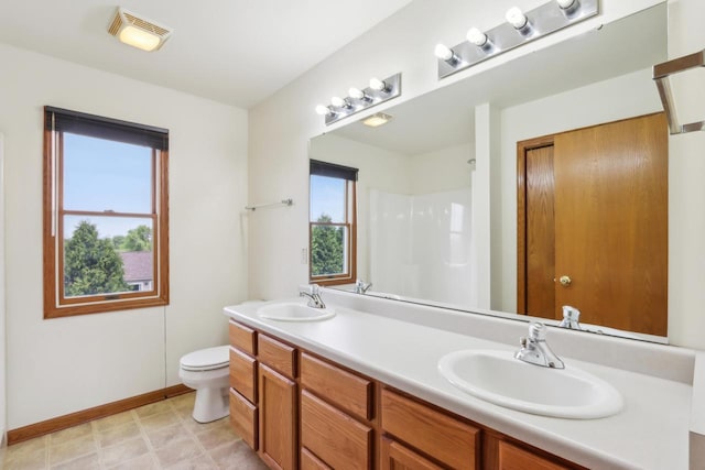 24434 88th St, Salem, WI 53168 - full bath featuring double vanity, toilet, baseboards, and a shower