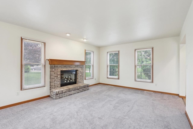 24434 88th St, Salem, WI 53168 - unfurnished living room with carpet flooring, baseboards, and a brick fireplace