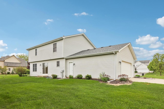 24434 88th St, Salem, WI 53168 - back of property with a lawn, an attached garage, and concrete driveway