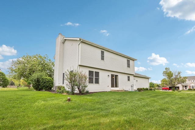 24434 88th St, Salem, WI 53168 - rear view of house featuring a chimney and a lawn