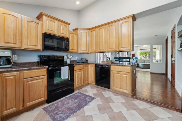 273 5th St, Fond Du Lac, WI 54935 - kitchen with black appliances, light brown cabinetry, recessed lighting, and dark stone countertops