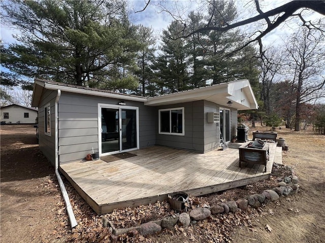415 S River, Spooner, WI 54801 - back of property with a deck and an outdoor fire pit